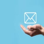 A hand is in a cupped position with the palm up over a teal background. A white envelope icon appears above the palm.