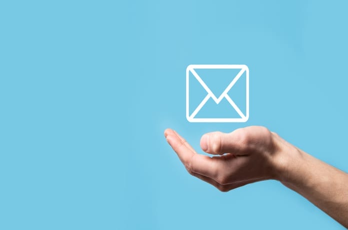 A hand is in a cupped position with the palm up over a teal background. A white envelope icon appears above the palm.